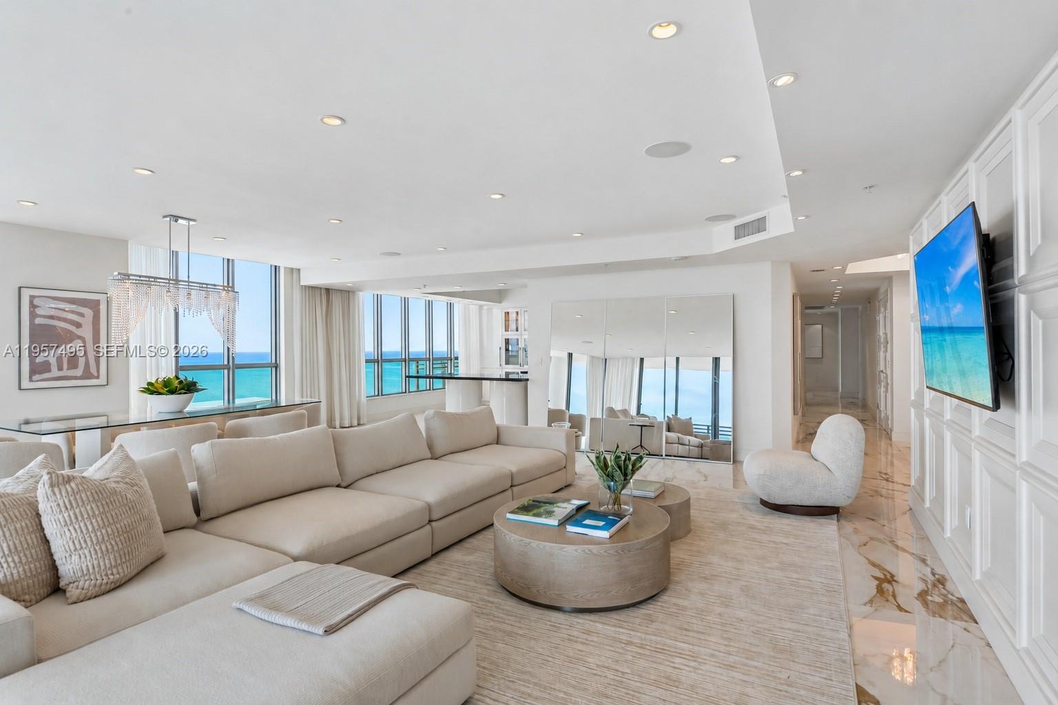 A modern living and dining area features floor-to-ceiling windows, marble floors, and ocean views — 3535 S Ocean Dr # 2106, Hollywood FL 33019, HOLLYWOOD, FL