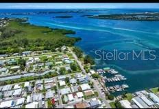 An aerial view shows a coastal neighborhood with many houses situated next to a marina — 3717 115TH STREET COURT W, BRADENTON, FL
