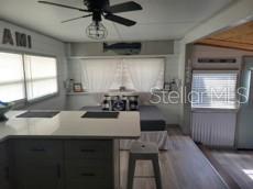 A kitchen features light gray cabinets, stainless steel appliances, and a white countertop — 3717 115TH STREET COURT W, BRADENTON, FL