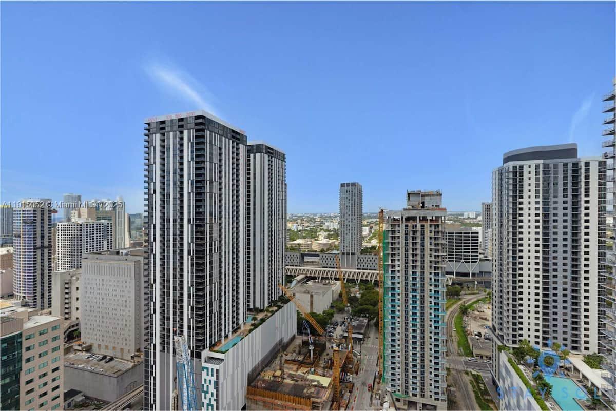 An elevated exterior view shows several modern high-rise buildings and an active construction site — 159 NE 6th St # 3004, Miami FL 33132, MIAMI, FL