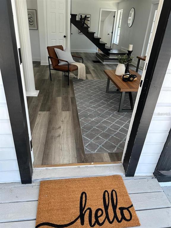 A view from a porch through a doorway into a living room with wood flooring — 1397 43RD STREET, SARASOTA, FL