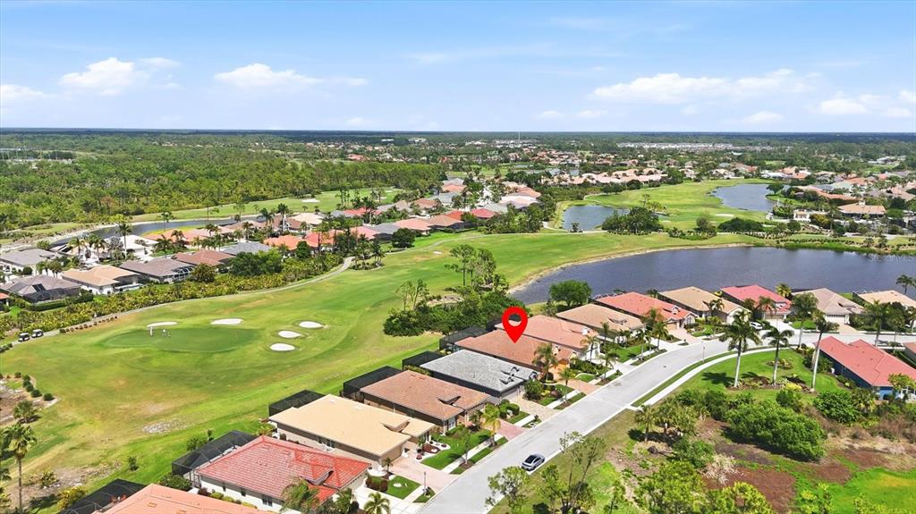 An aerial view shows a suburban house with a red pin on a golf course — 4811 BLUE HERON CIRCLE, NORTH PORT, FL