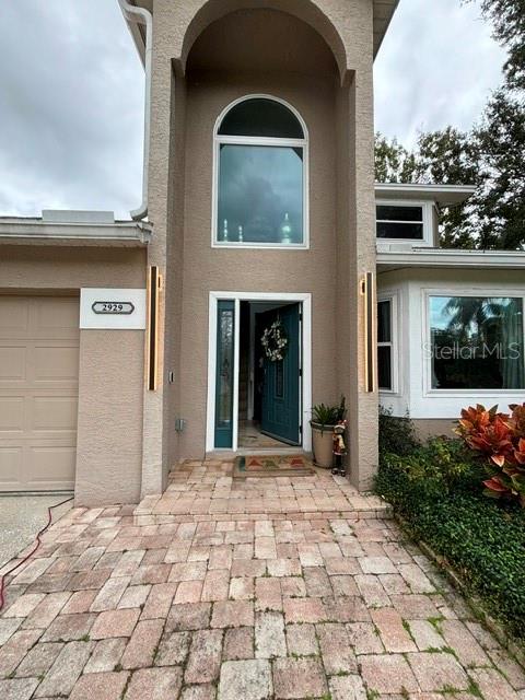 The exterior of a two-story house features a teal front door and a paved driveway — 2929 SOMERSWORTH COURT, ORLANDO, FL