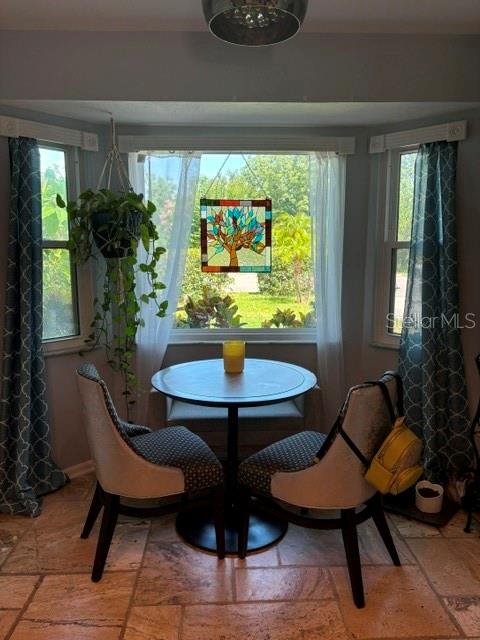 A breakfast nook features a round table, two chairs, and a stained-glass tree window hanging — 2929 SOMERSWORTH COURT, ORLANDO, FL