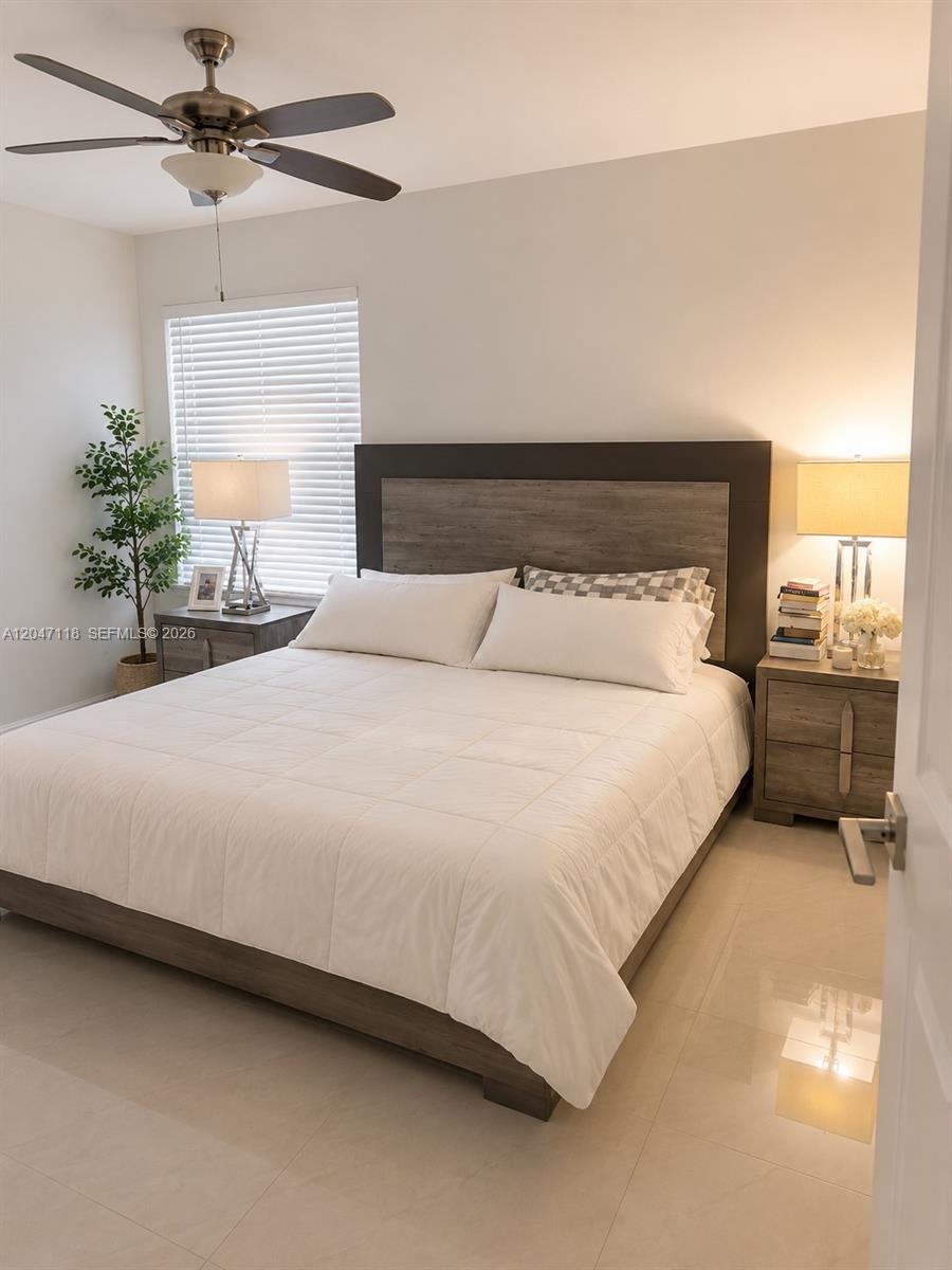 A bedroom features a bed with a wooden headboard, two nightstands, and a ceiling fan — 9280 SW 123rd Ct # 106, Miami FL 33186, MIAMI, FL