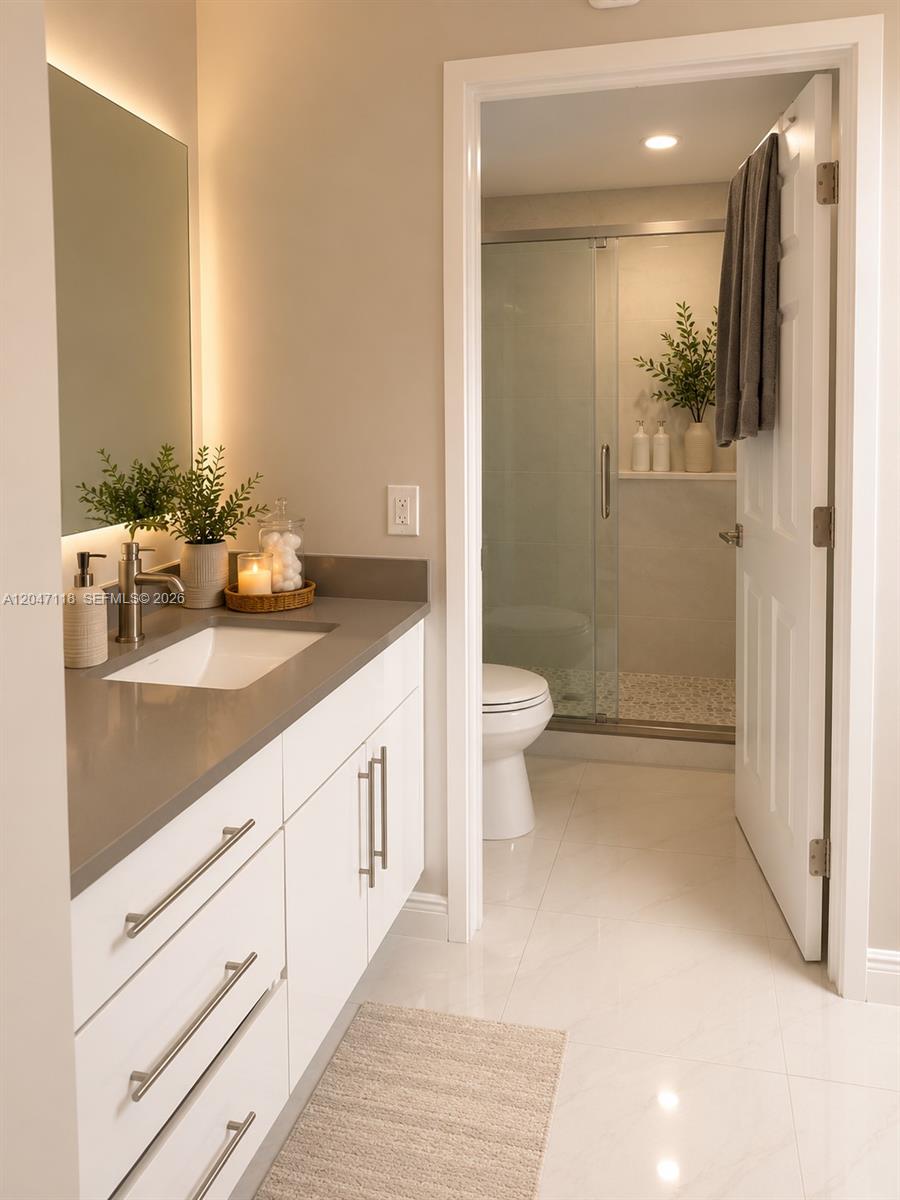 A modern bathroom features a white vanity with a gray countertop and an adjacent shower — 9280 SW 123rd Ct # 106, Miami FL 33186, MIAMI, FL