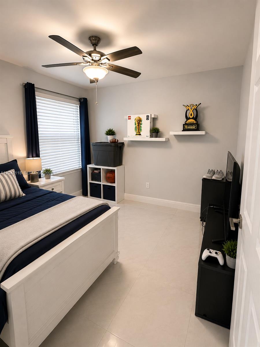 A bedroom features a white bed, a ceiling fan, floating shelves, and tile flooring — 9280 SW 123rd Ct # 106, Miami FL 33186, MIAMI, FL