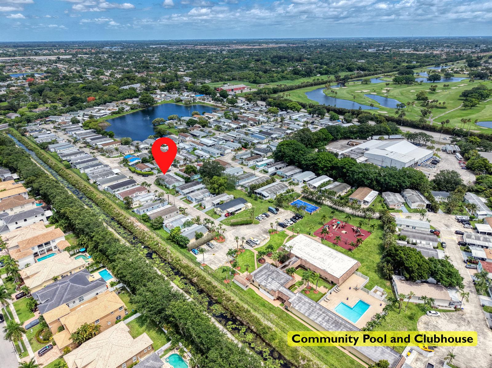 Aerial view of a mobile home community featuring a clubhouse, pool, and nearby golf course — 59 Plantation Blvd, Lake Worth FL 33467, LAKE WORTH, FL