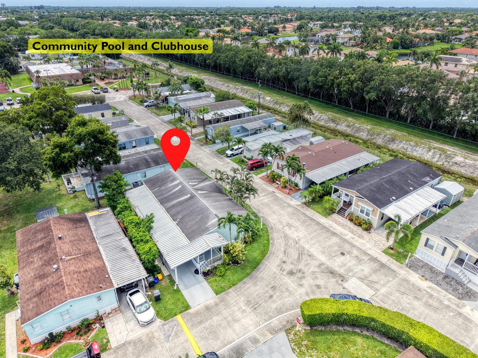 An aerial view shows a residential street with several manufactured homes and a community clubhouse — 59 Plantation Blvd, Lake Worth FL 33467, LAKE WORTH, FL