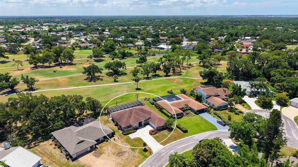 An aerial view shows a single-story house with a screened pool enclosure and driveway — 4360 BRANDYWINE DRIVE, SARASOTA, FL