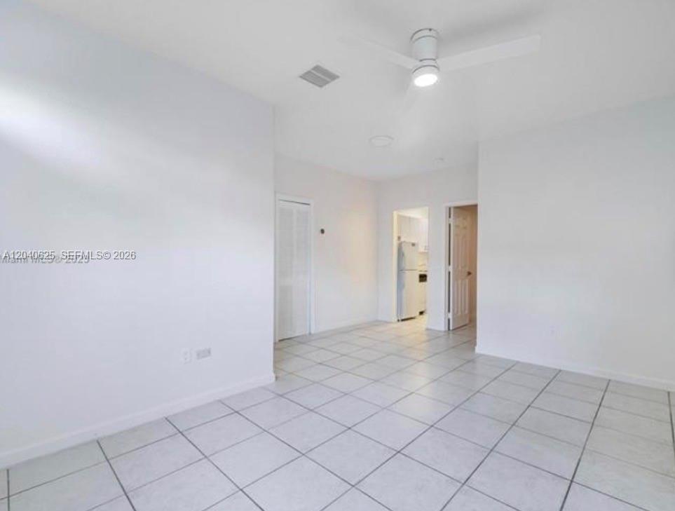 A bright, empty room features white walls, light-colored floor tiles, and a ceiling fan — 822 Lenox Ave # 5, Miami Beach FL 33139, MIAMI BEACH, FL
