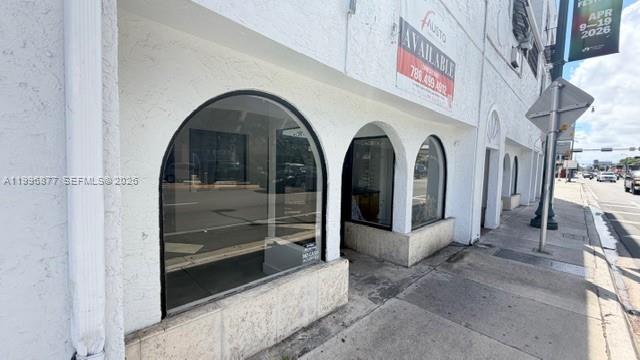 The exterior of a white commercial building features arched windows along a sidewalk — 2606 SW 8th St, Miami FL 33135, MIAMI, FL