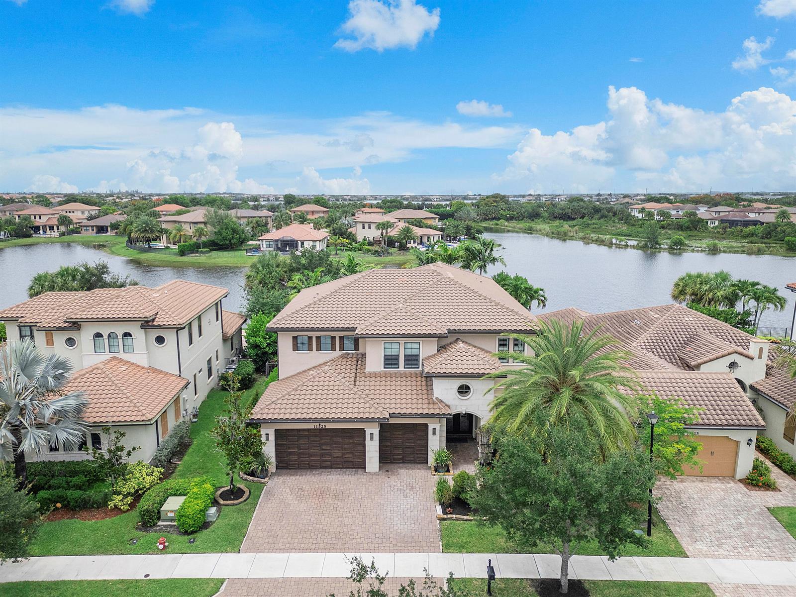 An aerial view shows a two-story house with a tiled roof and a paved driveway — 11525 NW 81st Place, Parkland FL 33076, PARKLAND, FL