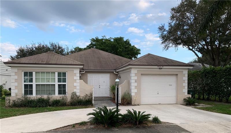 A single-story house with a beige exterior, white trim, a garage, and a paved driveway — 96 Del Rio Boulevard, Boca Raton FL 33432, BOCA RATON, FL
