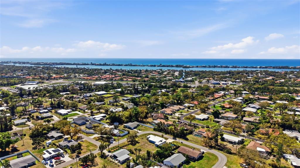 An aerial view of a residential neighborhood near a coastal waterway and the ocean — PALMETTO STREET, NOKOMIS, FL