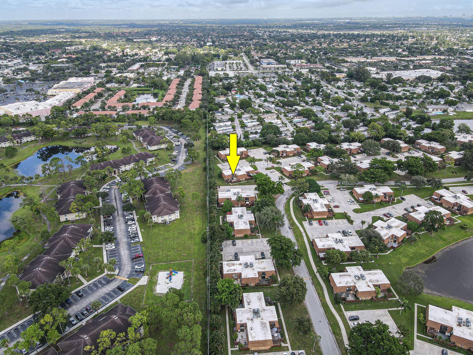 An aerial view shows a residential complex with a yellow arrow pointing to a unit — 2406 24th Lane, FL 33463, FL