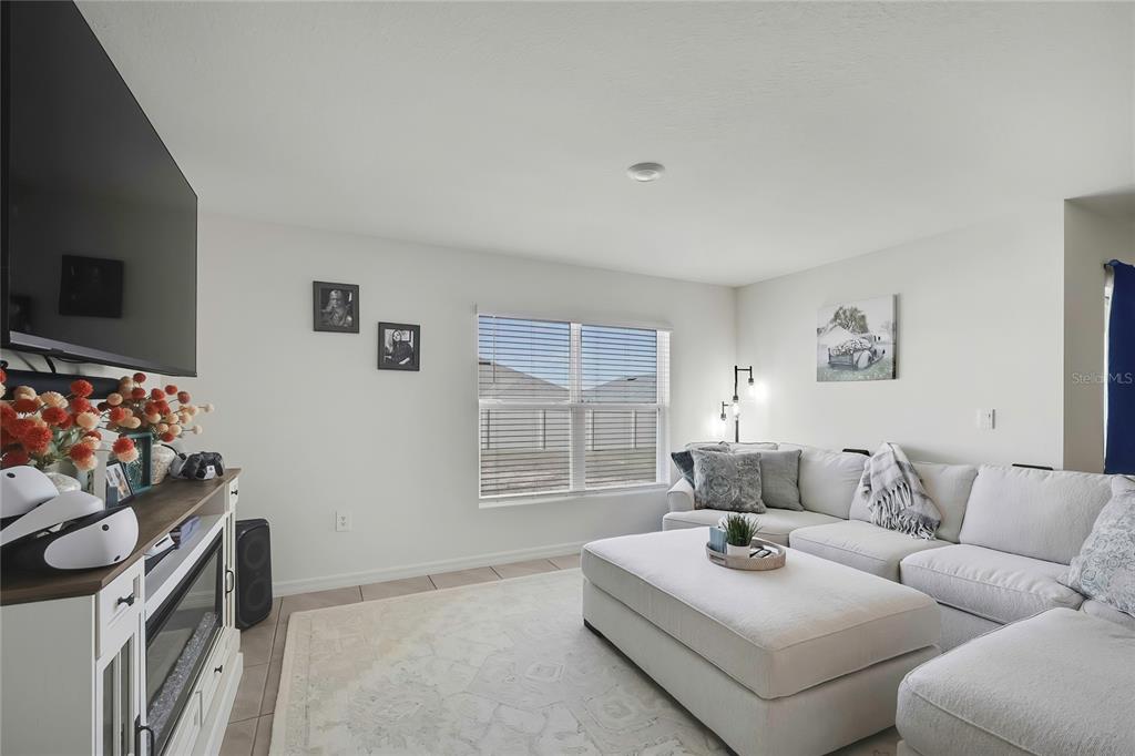 A living room features a white sectional sofa, a large ottoman, and a media console — 377 W FAIRWAYS VIEW DRIVE, BEVERLY HILLS, FL