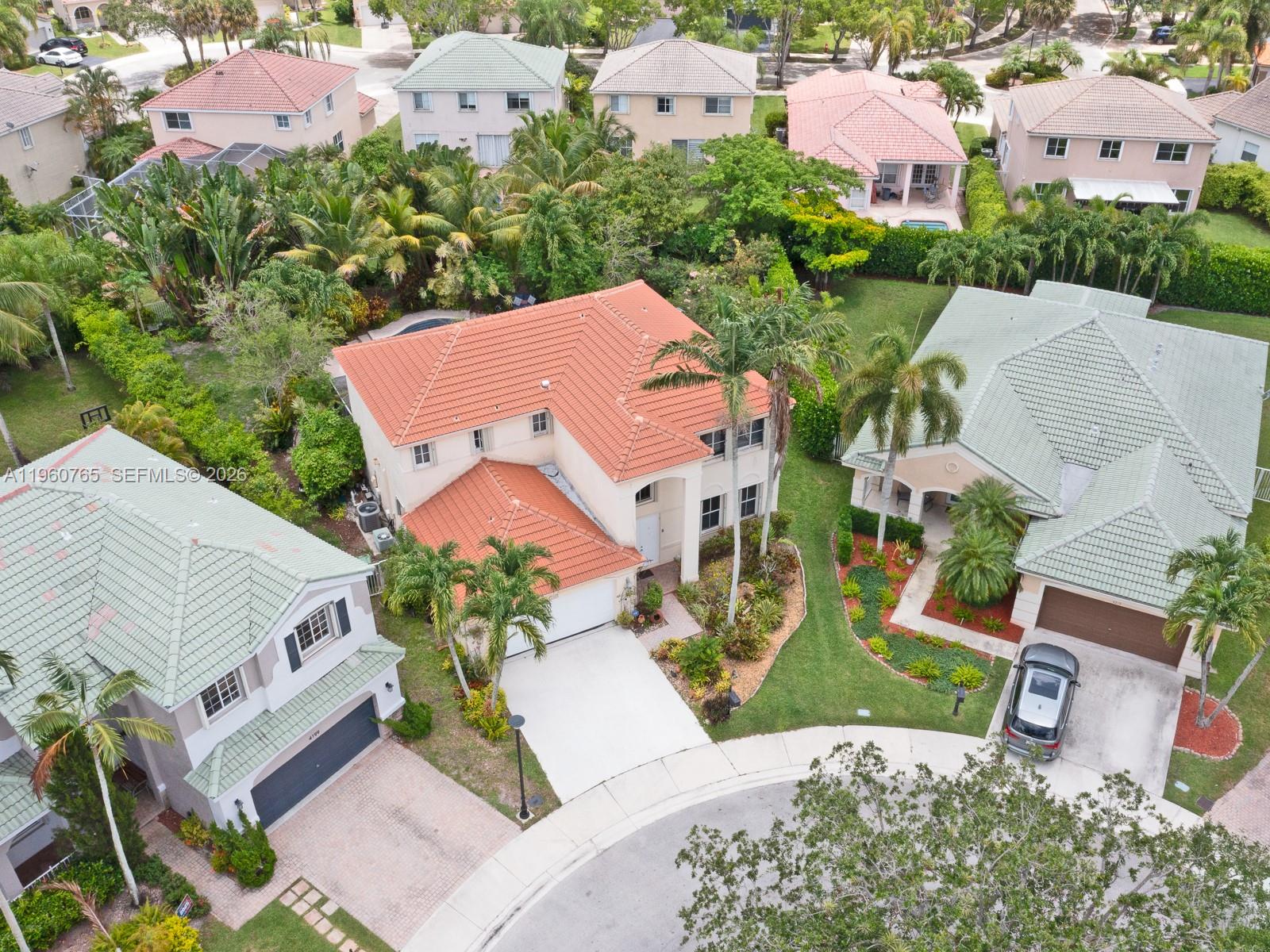 An aerial view shows a two-story house with a red tile roof in a neighborhood — 4209 Pinewood Ln, Weston FL 33331, WESTON, FL