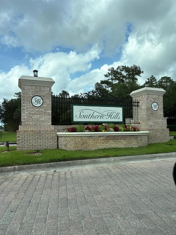 A brick entrance monument with a sign reading Southern Hills stands beside a paved road — 0 BROAD STREET, BROOKSVILLE, FL