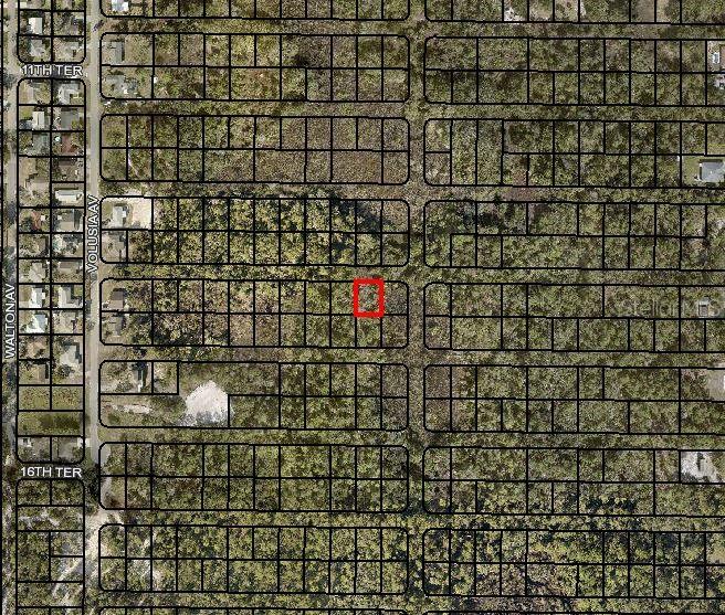 This is an aerial map showing a highlighted vacant lot within a residential grid — Lot 2 VOLUSIA AVENUE, TITUSVILLE, FL