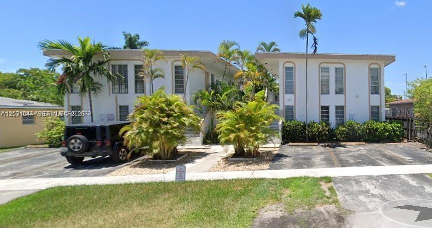A two-story apartment building with palm trees and a parked black SUV in front — 1610 Liberty St # 1, Hollywood FL 33020, HOLLYWOOD, FL