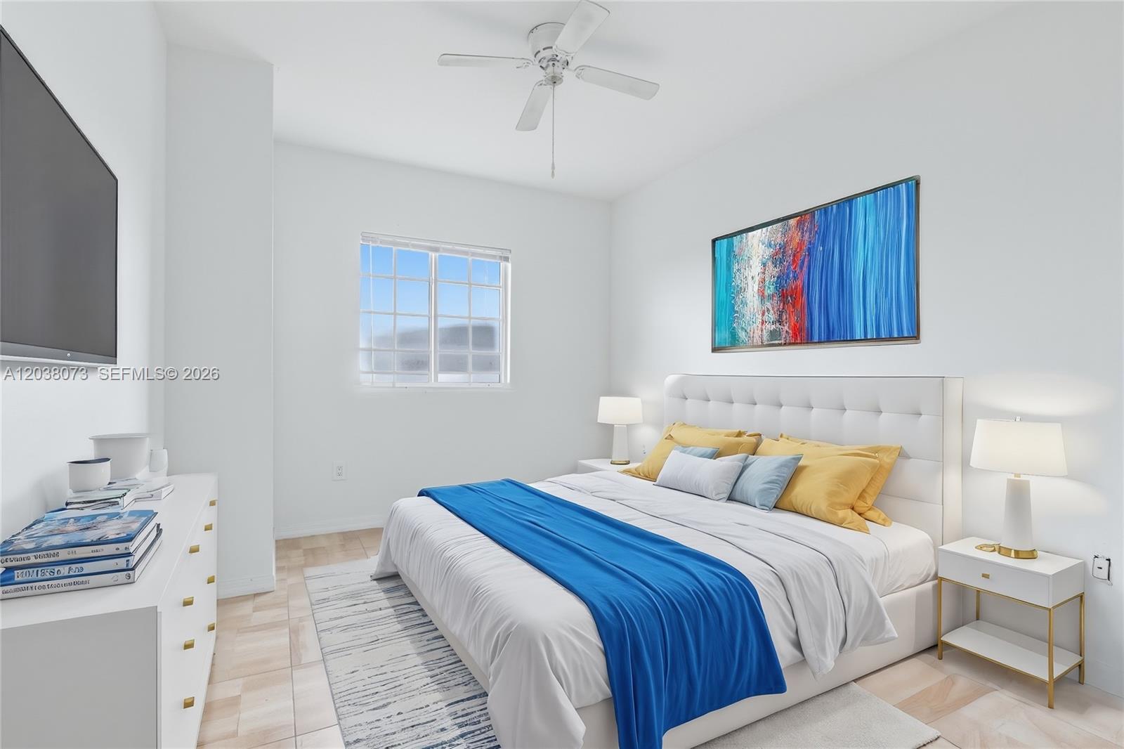 A bedroom features a white tufted bed, blue accent decor, and a ceiling fan — 5271 SW 8th St # 304, Miami FL 33134, MIAMI, FL
