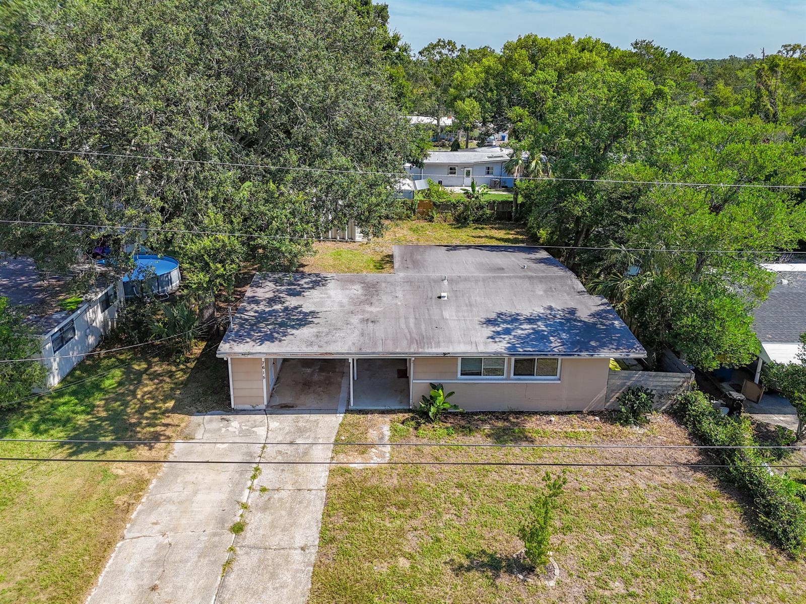 An aerial view of a single-story house with a flat roof and an attached carport — 7615 Mayapple Road, Jacksonville FL 32211, JACKSONVILLE, FL