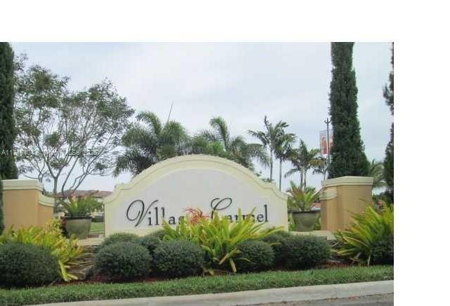A sign for Villas Carmel stands in front of landscaping and palm trees — 1420 NE 33rd Ave # 15, Homestead FL 33033, HOMESTEAD, FL