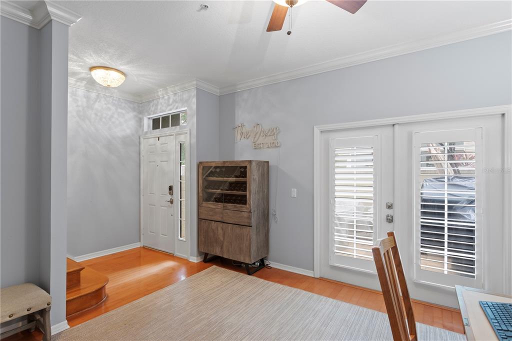 A room with hardwood floors, a wine cabinet, a front door, and glass patio doors — 1425 HARBOUR WALK ROAD, TAMPA, FL