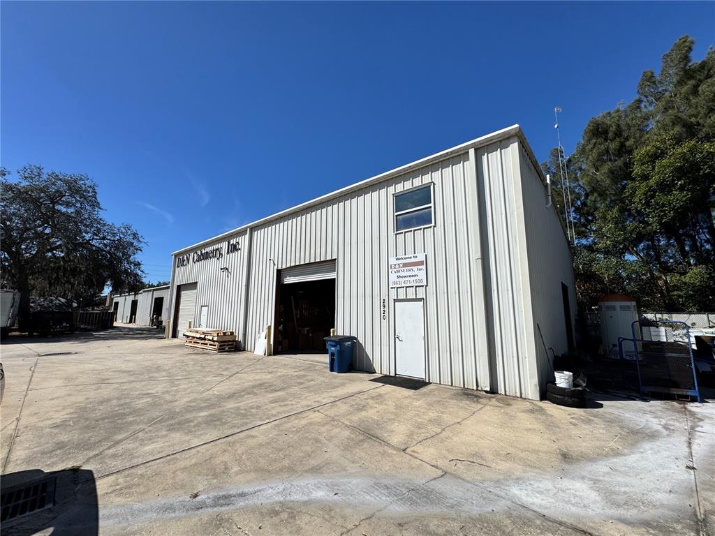 A metal industrial building with a large open bay and a small entrance door — 2914 KENILWORTH BOULEVARD, SEBRING, FL