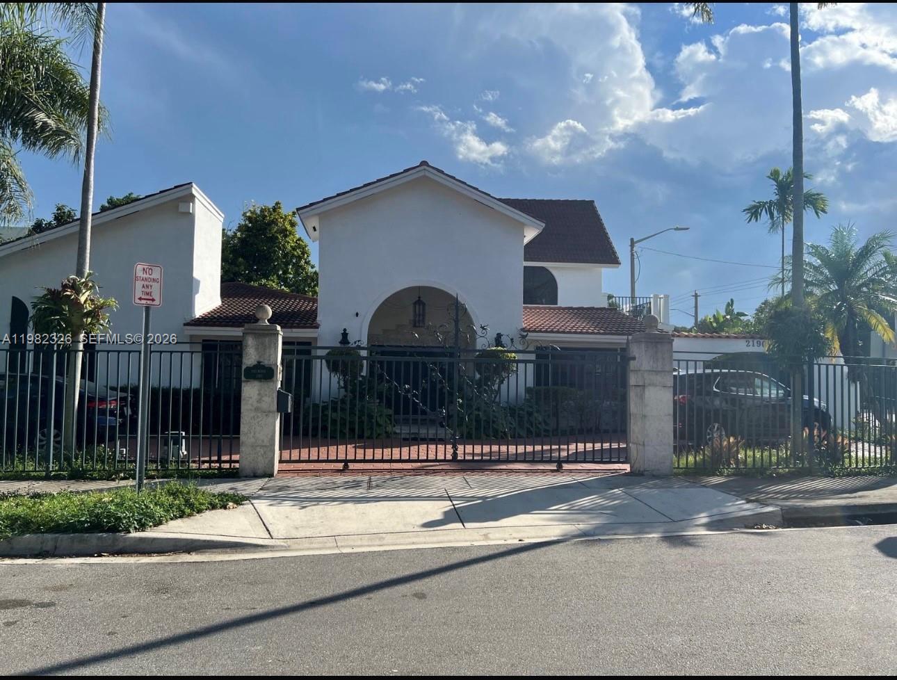 A white house with a red tile roof is enclosed by a black metal fence — 2190 SW 22 terrace, Miami FL 33145, MIAMI, FL