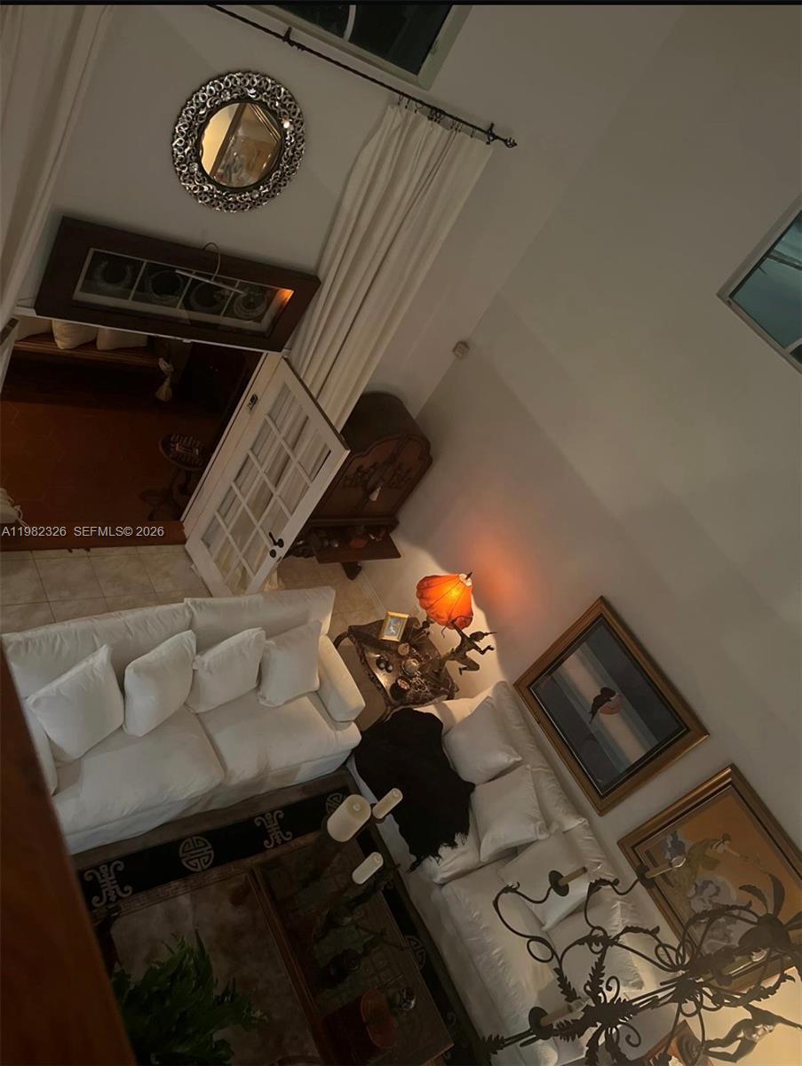 A high-angle view of a living room with white sofas, high ceilings, and framed artwork — 2190 SW 22 terrace, Miami FL 33145, MIAMI, FL