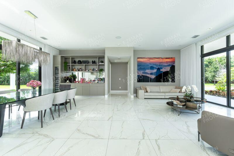 A modern open-concept living and dining area features white marble floors and floor-to-ceiling windows — 16550 Sunset Way, Weston FL 33326, WESTON, FL
