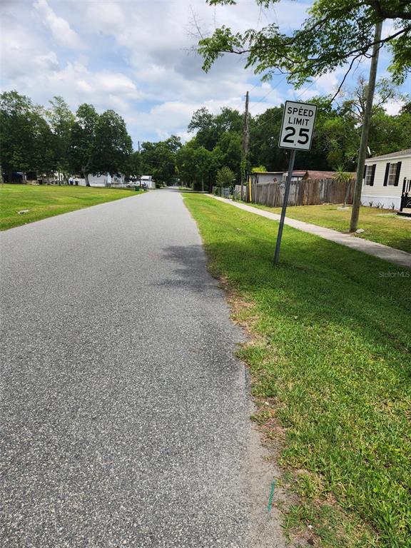 A paved residential street features a speed limit sign on the right side — 9653 4TH AVENUE, ORLANDO, FL