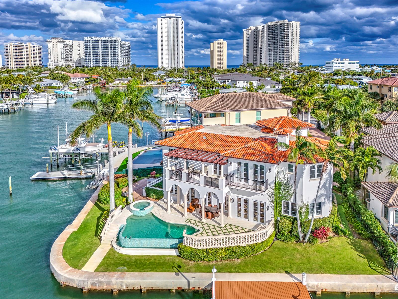 An aerial view of a waterfront Mediterranean-style house with a pool and boat dock — 2775 Lake Drive, Singer Island FL 33404, SINGER ISLAND, FL