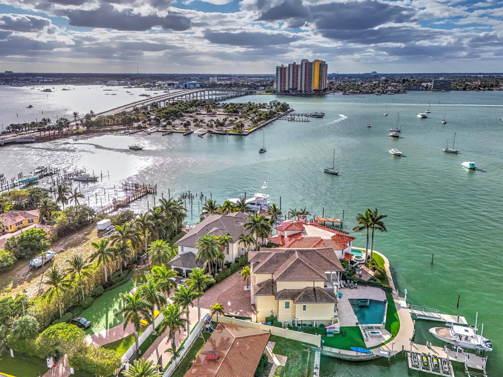 An aerial view shows a waterfront estate with a pool, dock, and boat slips — 2775 Lake Drive, Singer Island FL 33404, SINGER ISLAND, FL
