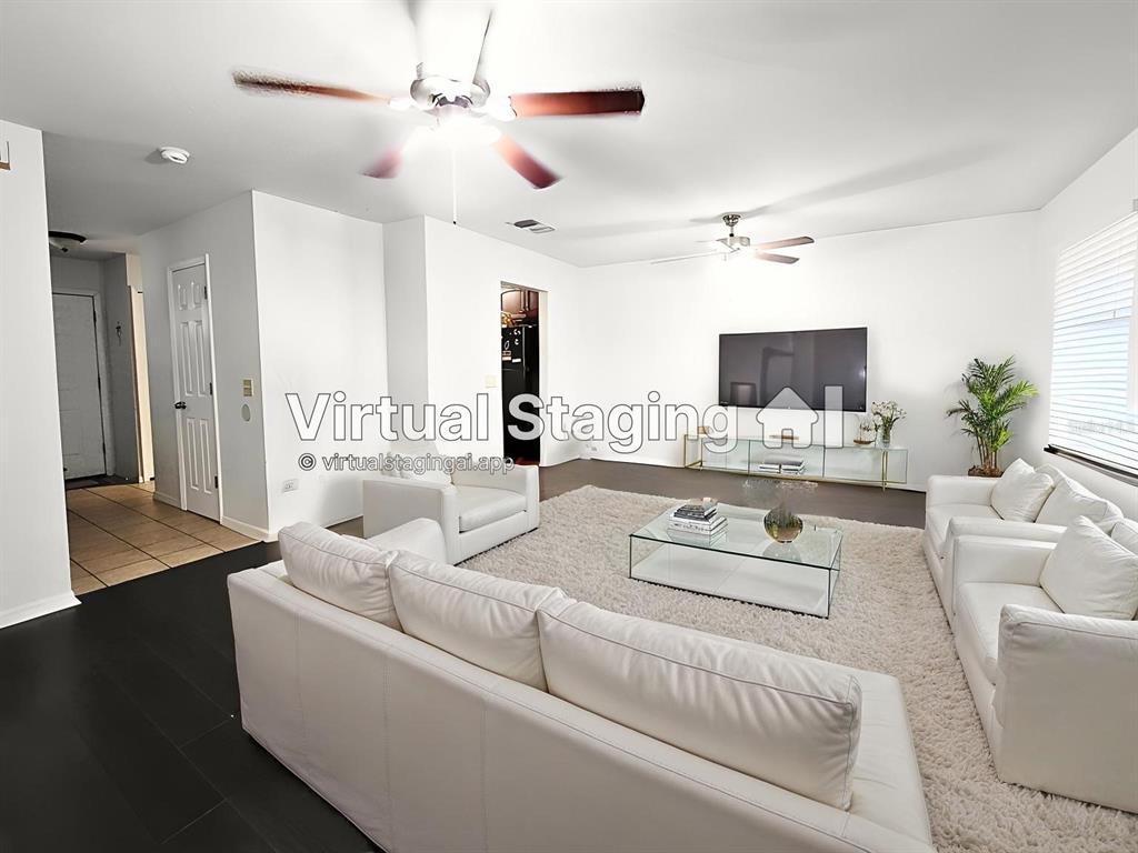 This living room features dark wood floors, white walls, a ceiling fan, and virtual furniture — 11807 MINTWOOD COURT, ORLANDO, FL