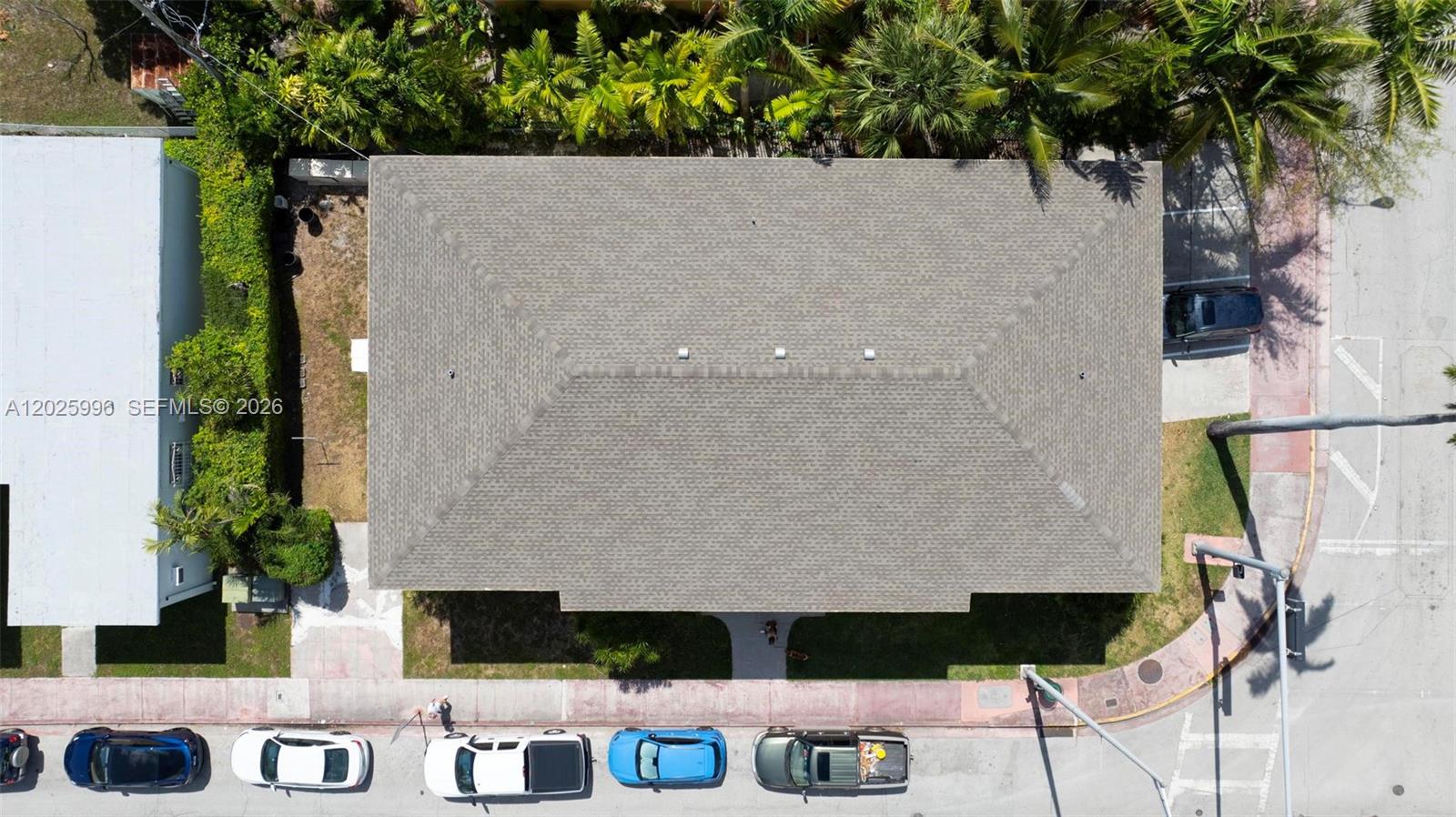 An aerial view shows a house with a shingled hip roof surrounded by palm trees — 1460 E West Ave, Miami Beach FL 33139, MIAMI BEACH, FL