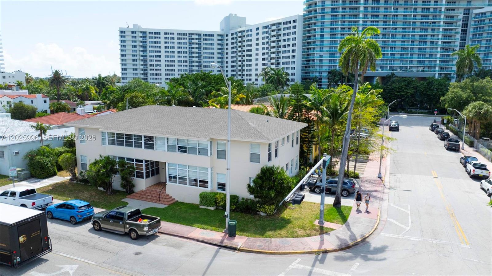 An aerial view shows a two-story apartment building on a corner lot with parked cars — 1460 E West Ave, Miami Beach FL 33139, MIAMI BEACH, FL