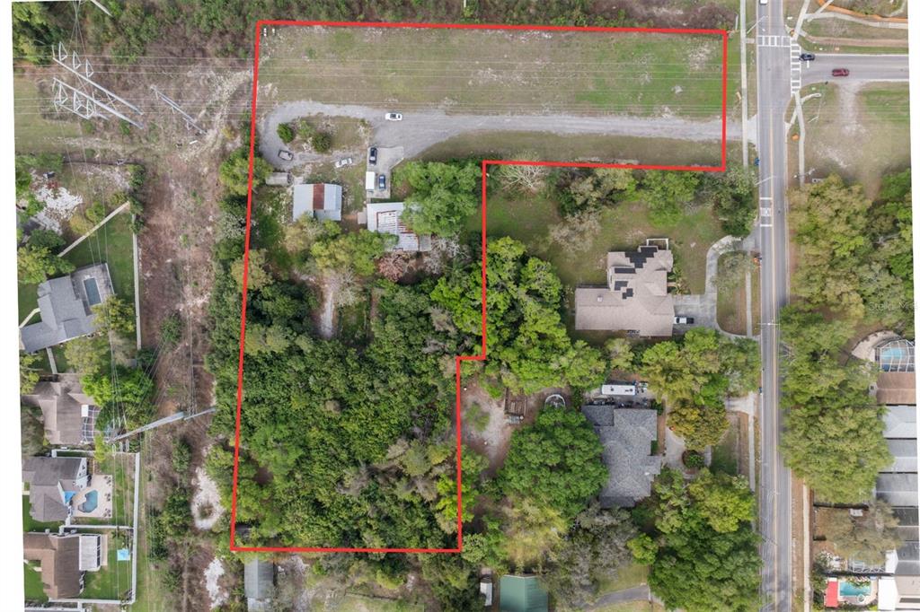 An aerial view shows a residential lot outlined in red with trees and structures — 6890 COUNTY ROAD 95, PALM HARBOR, FL