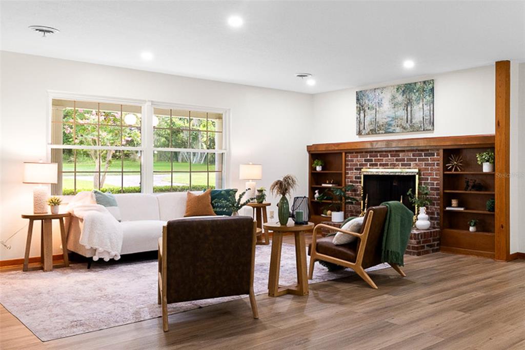 A living room features a brick fireplace, built-in wooden shelving, and a white sofa — 130 SW 69TH STREET, OCALA, FL