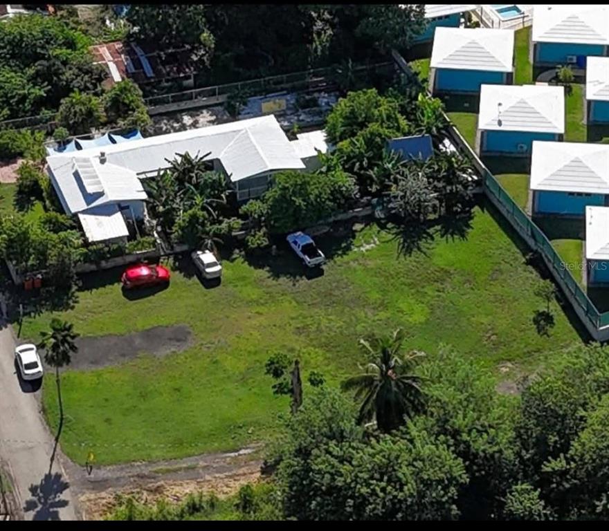 An aerial view shows a house with a white roof next to a large grassy yard — 429 KM 0.3 POGIO DOLETA STREET UNIT 1, RINCON, PR