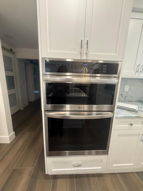 A stainless steel LG double wall oven is installed in white cabinetry in a kitchen — 5520 N Ocean Boulevard # 111, Ocean Ridge FL 33435, OCEAN RIDGE, FL