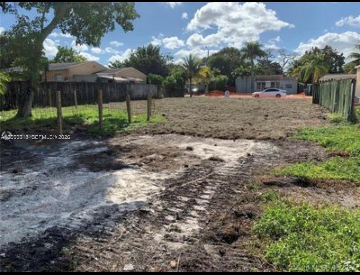 A vacant, cleared residential lot features a dirt ground surface and a wooden perimeter fence — 601 sw 44th ct, Miami FL 33134, MIAMI, FL