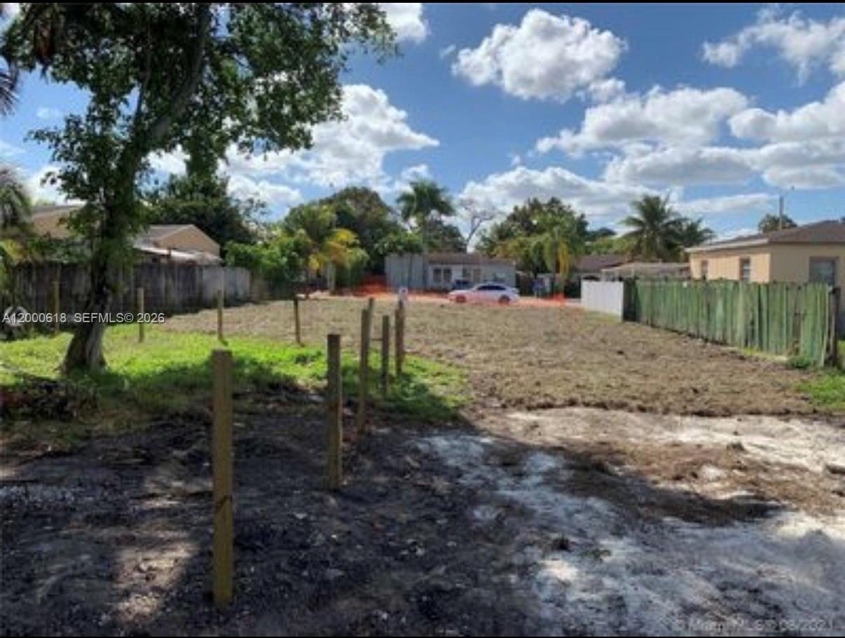 A vacant, fenced-in residential lot features bare soil and a few scattered trees — 601 sw 44th ct, Miami FL 33134, MIAMI, FL