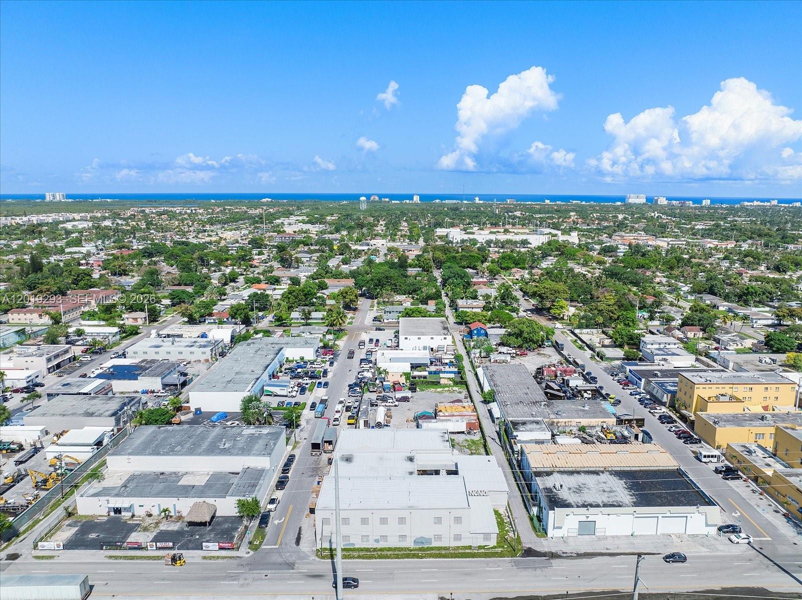 An aerial view shows a commercial industrial area with flat-roofed warehouses and surrounding residential neighborhoods — 2040 Liberty St, Hollywood FL 33020, HOLLYWOOD, FL