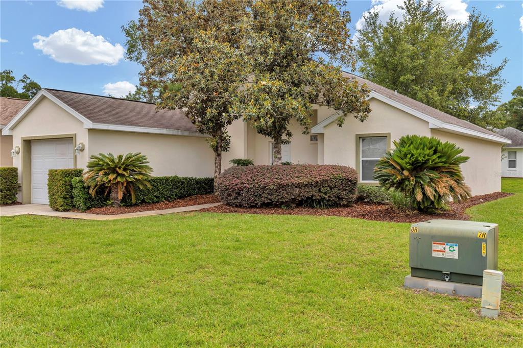 A single-story house with a garage, landscaping, and a utility box in the front yard — 7296 SW 112TH PLACE, OCALA, FL