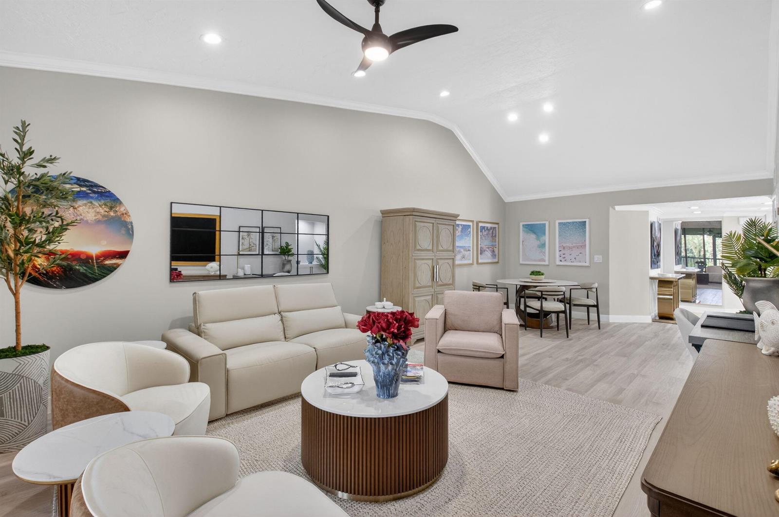 A living room with vaulted ceilings, a beige sofa, armchairs, and a round coffee table — 7455 Glendevon Lane # 206, Delray Beach FL 33446, DELRAY BEACH, FL