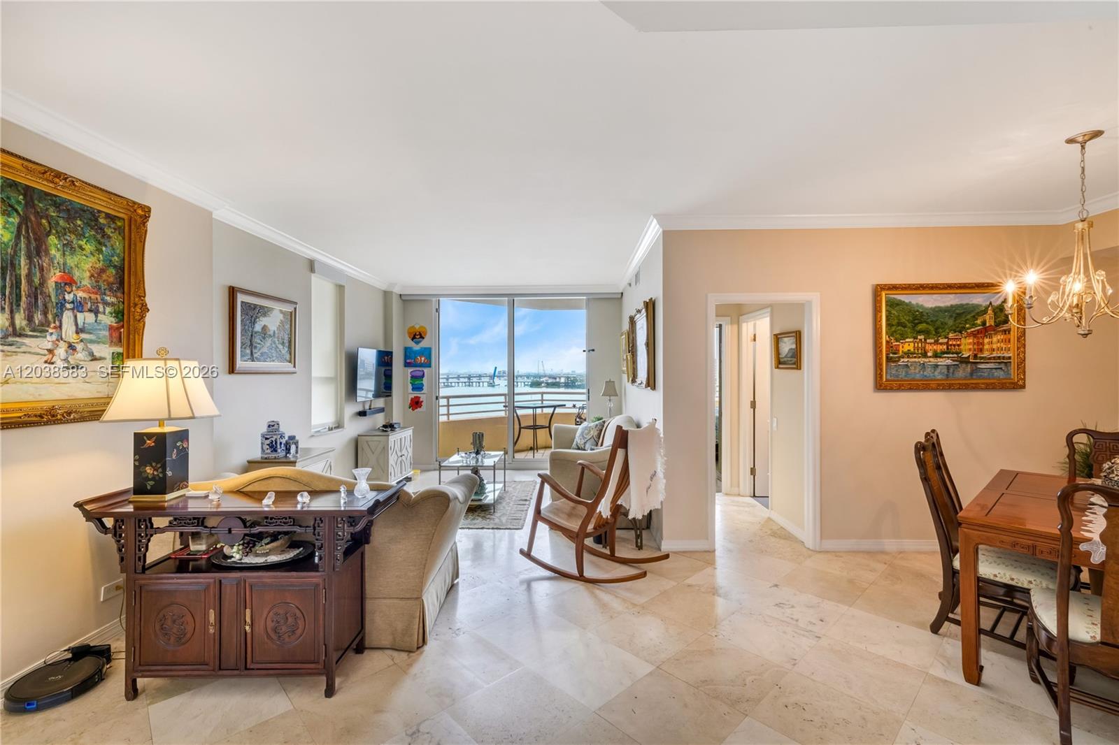 A living and dining area with tile floors, a balcony, and views of the water — 888 Brickell Key Dr # 1010, Miami FL 33131, MIAMI, FL
