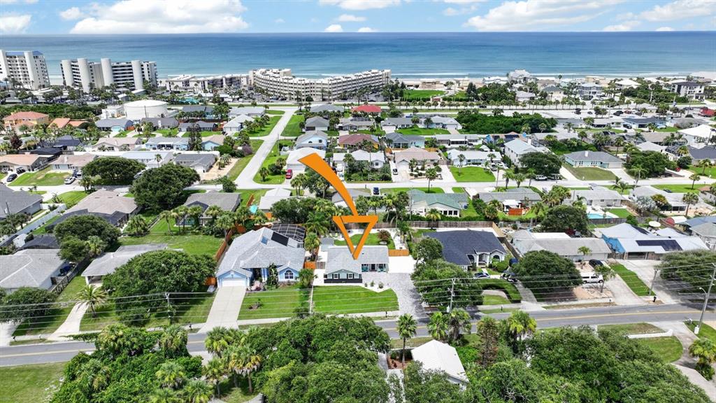 An aerial view shows a residential neighborhood near the beach with a highlighted house — 4503 SAXON DRIVE, NEW SMYRNA BEACH, FL